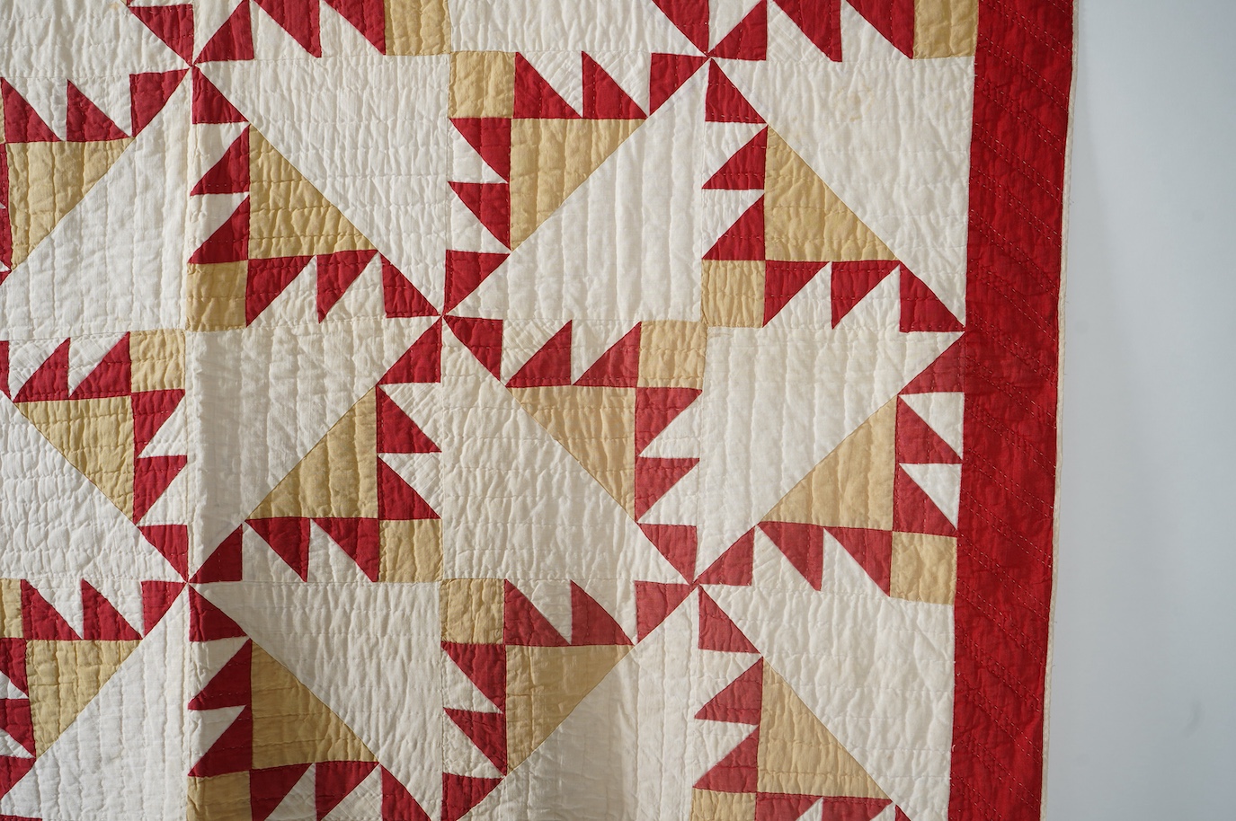 An early 1920’s-30’s American Virginian hand patch work, hand quilted bed cover. Called ‘Delectable Mountain Block’, worked in plain cottons of red, white and ochre, with a plain white backing and simple wadding. 182cm x